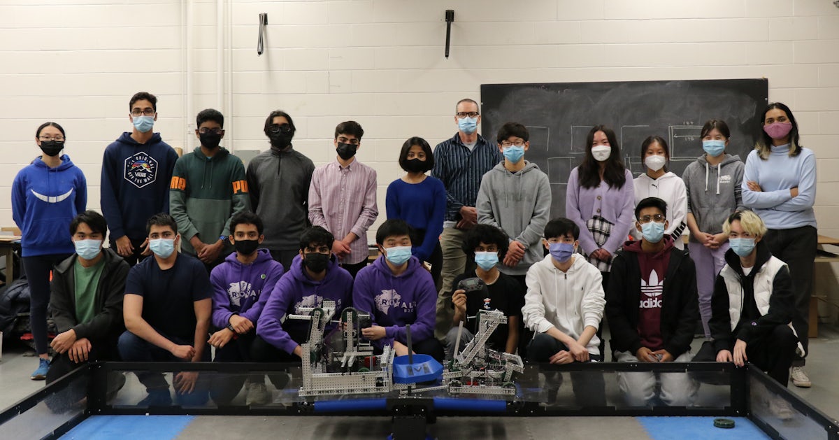 Team A, Team B, and general members with both teams' robots during Tipping Point